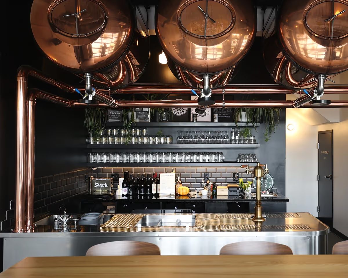 Copper Czech brewhouse vessels behind the Sacred Profane bar