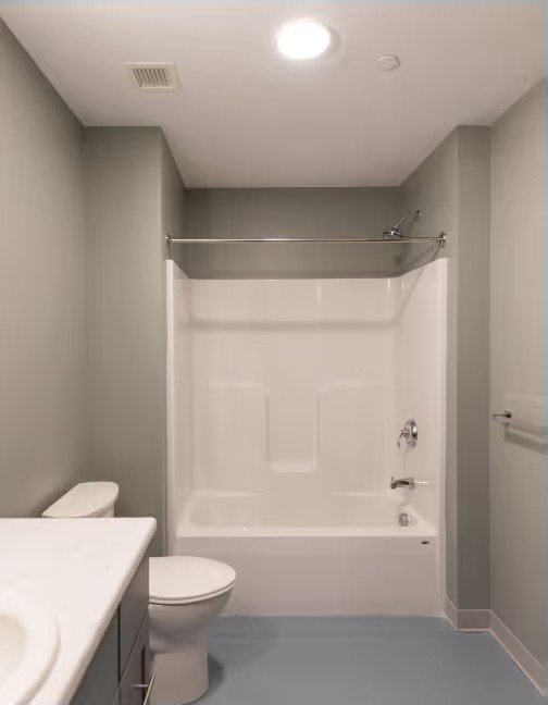 Finished unit bathroom with tub and vanity